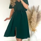 Sukienka z rozporkiem w kolorze butelkowej zieleni, w pasie gumka plus pasek. Skład: 70% wiskoza, 30% poliester Rozmiary: 2XL, 3XL długość całkowita 120 Rozmiar 2XL 44 Biust od 110 do 126 Pas do 118 Rozmiar 3XL 46 Biust od 115 do 130 Pas do 120 Cena 139 zł