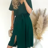 Sukienka z rozporkiem w kolorze butelkowej zieleni, w pasie gumka plus pasek. Skład: 70% wiskoza, 30% poliester Rozmiary: 2XL, 3XL długość całkowita 120 Rozmiar 2XL 44 Biust od 110 do 126 Pas do 118 Rozmiar 3XL 46 Biust od 115 do 130 Pas do 120 Cena 139 zł